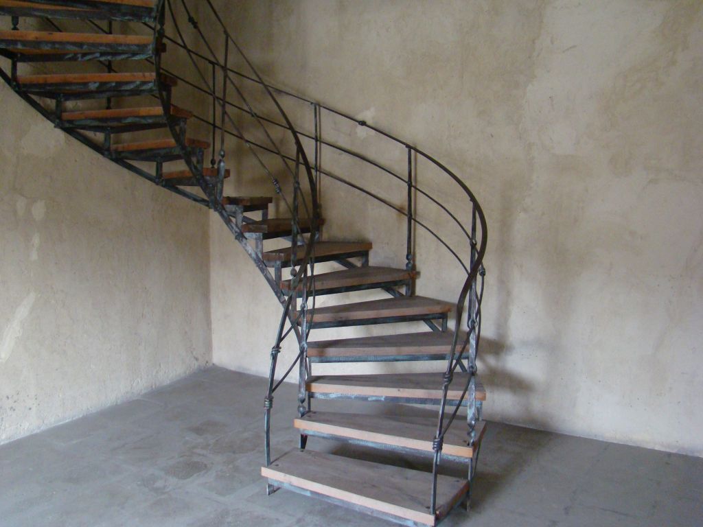 Curved metal stairs heading up to the Georgian Flag
