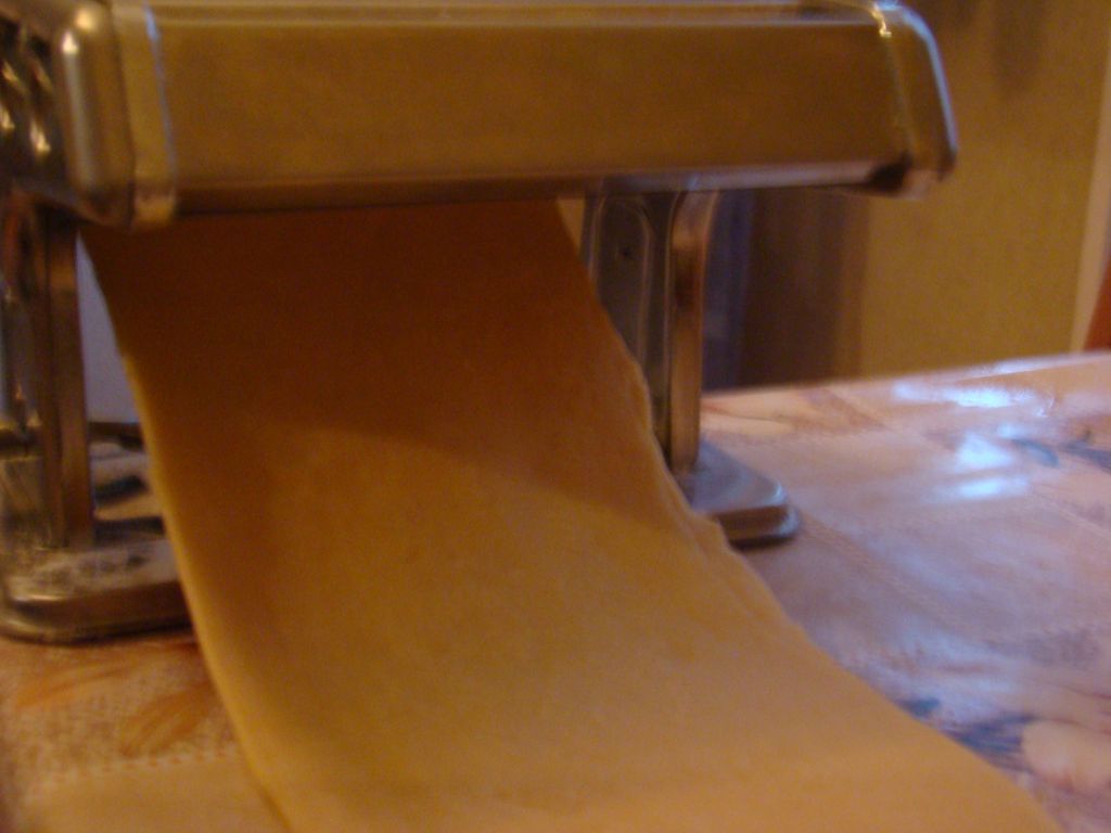 Pasta being rolled out using macaroni machine