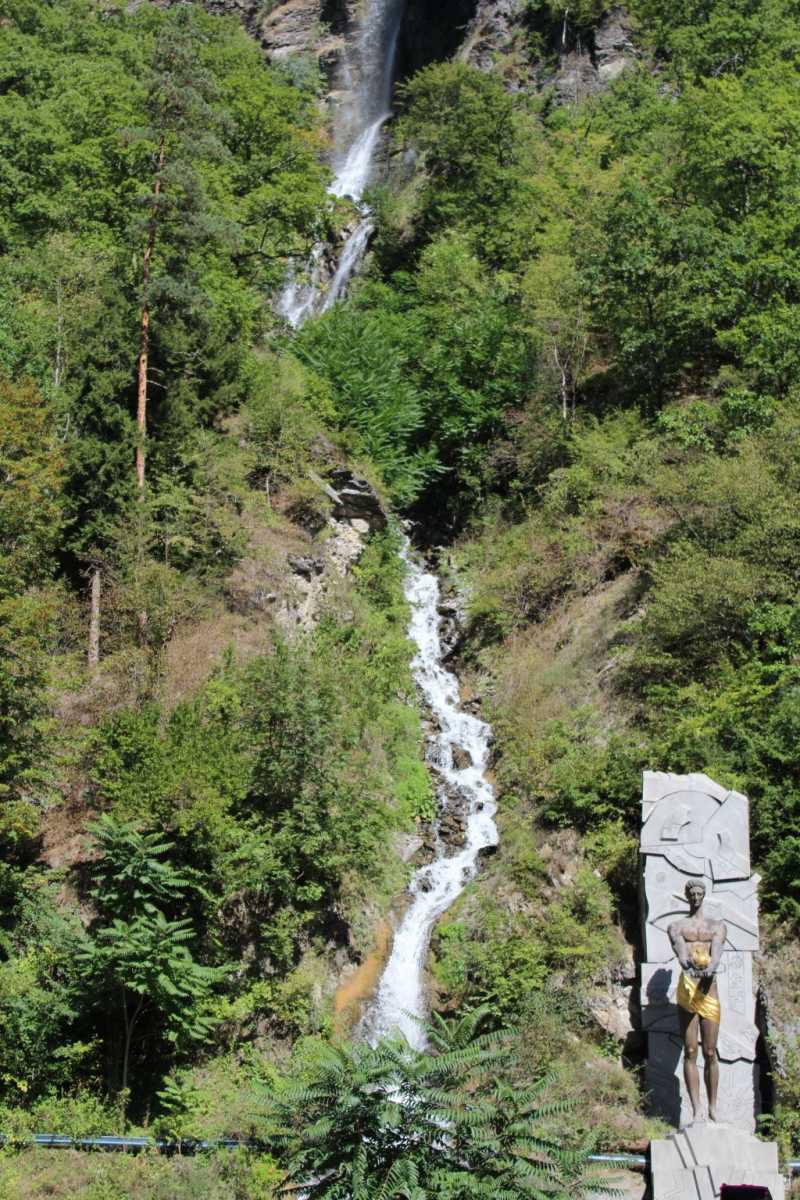 Waterfall and a monument in Borjomi Mineral Water Park