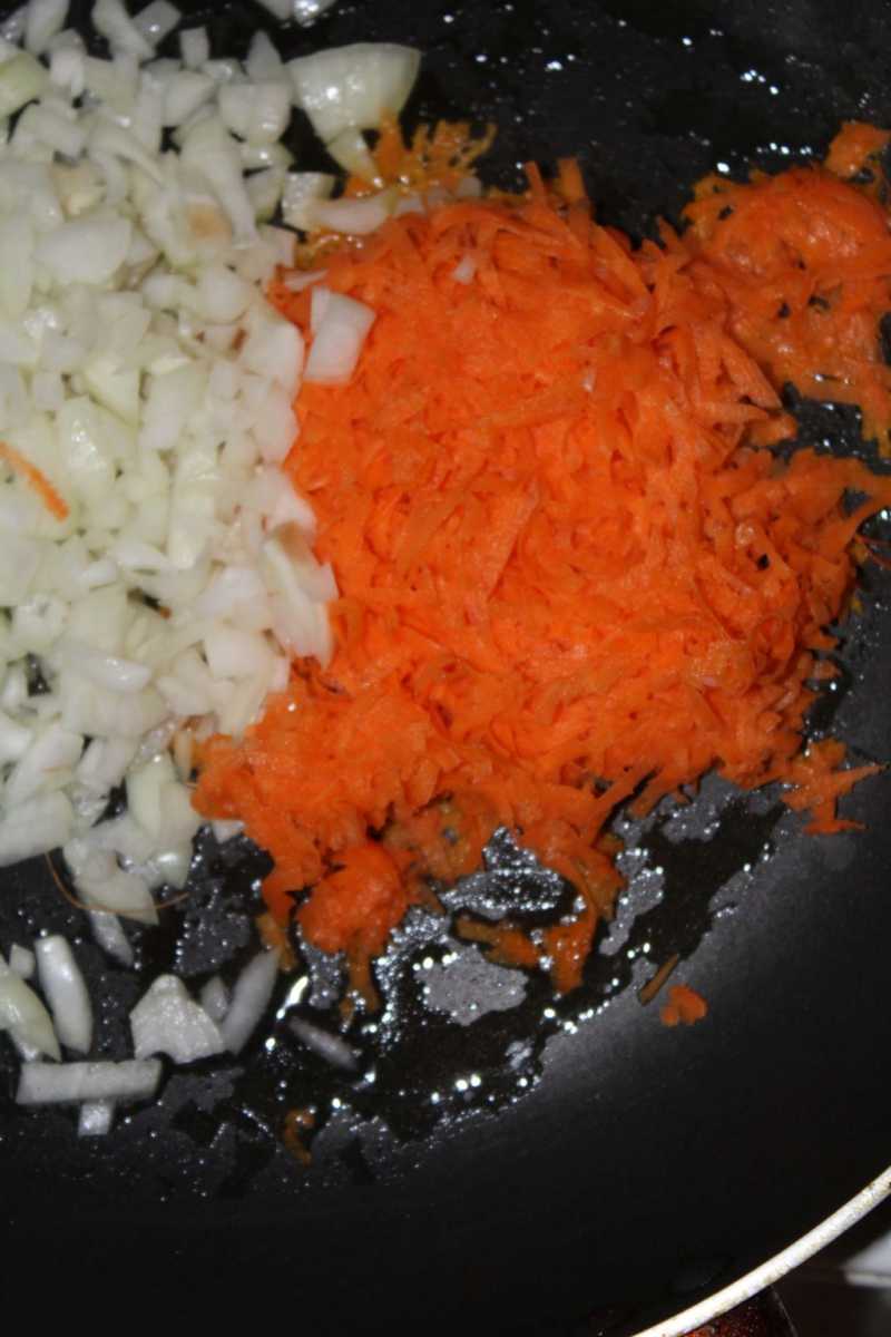 Add grated carrots and chopped onions to the pan