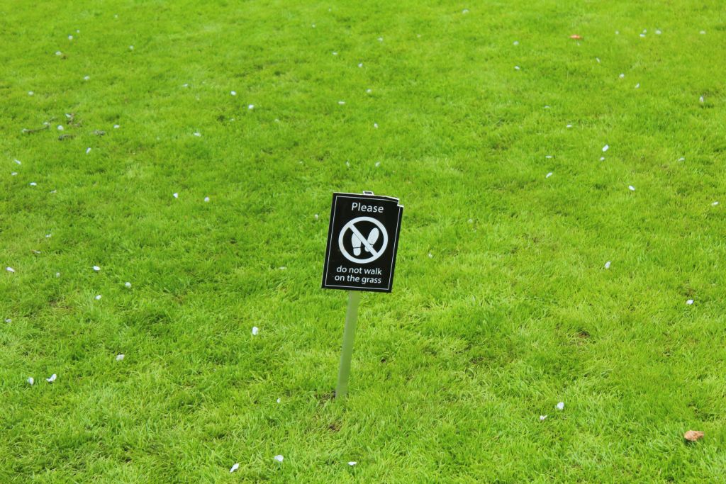 Please don't walk on the grass sign