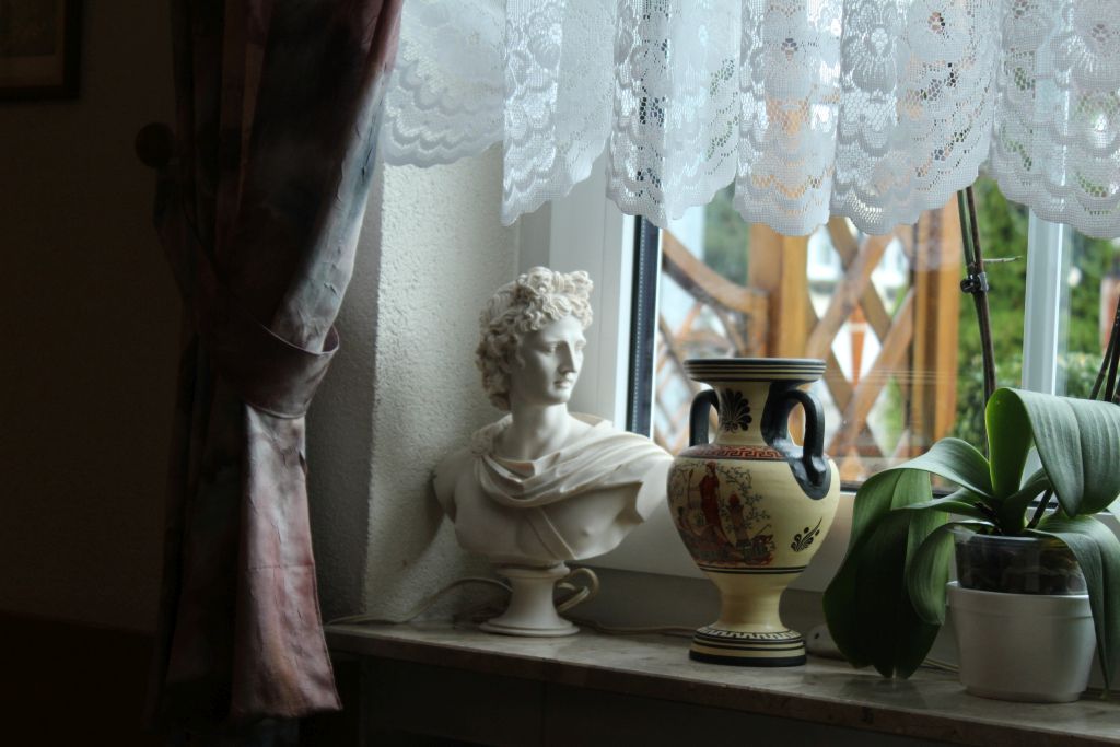 Greek sculpture head and a vase