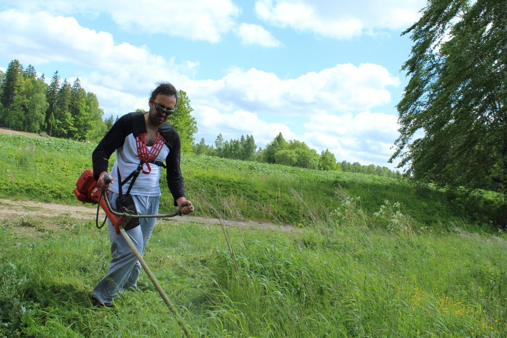 Author of this blog fighting grass with a trimmer