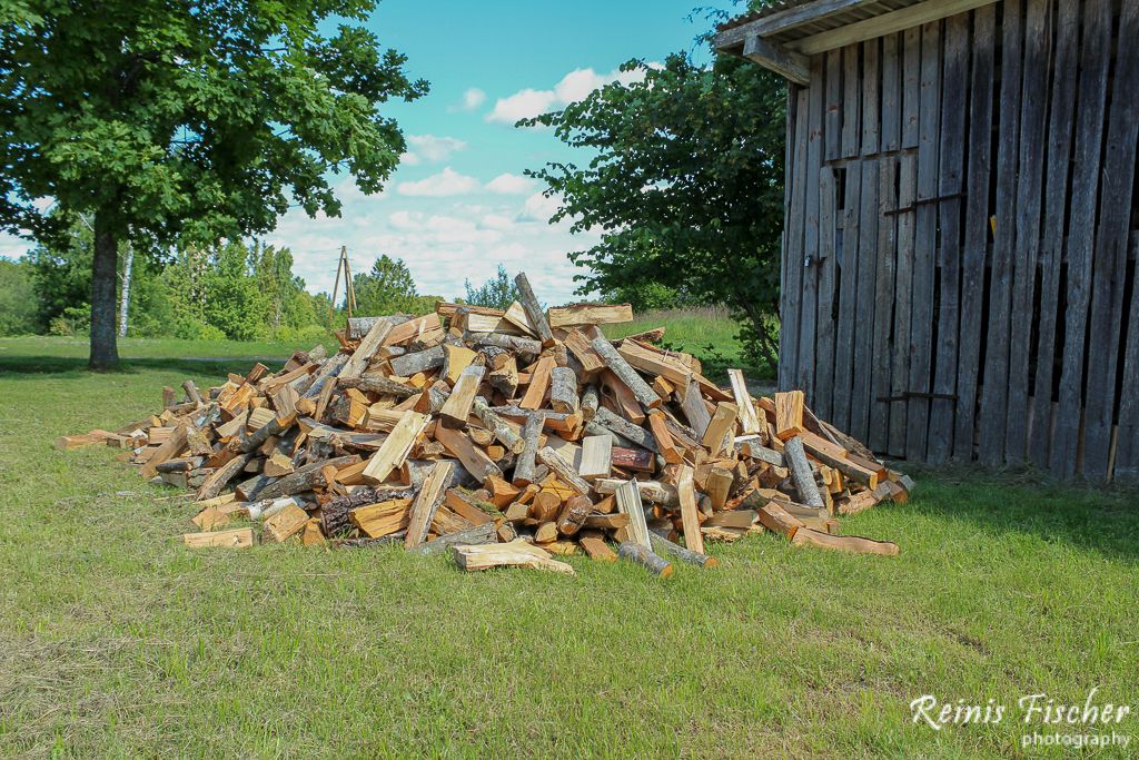 Firewood waiting to be stacked in barn