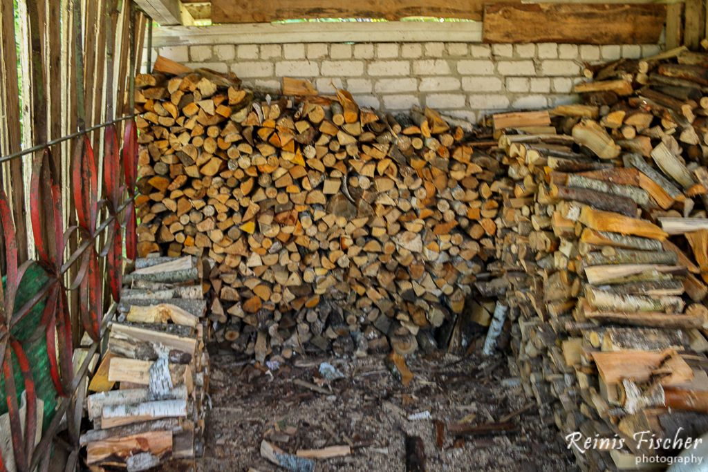 Stacking firewood in barn