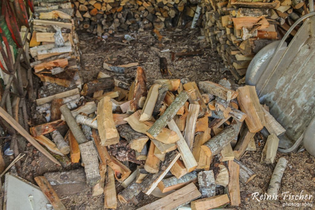 Stacking firewood in barn