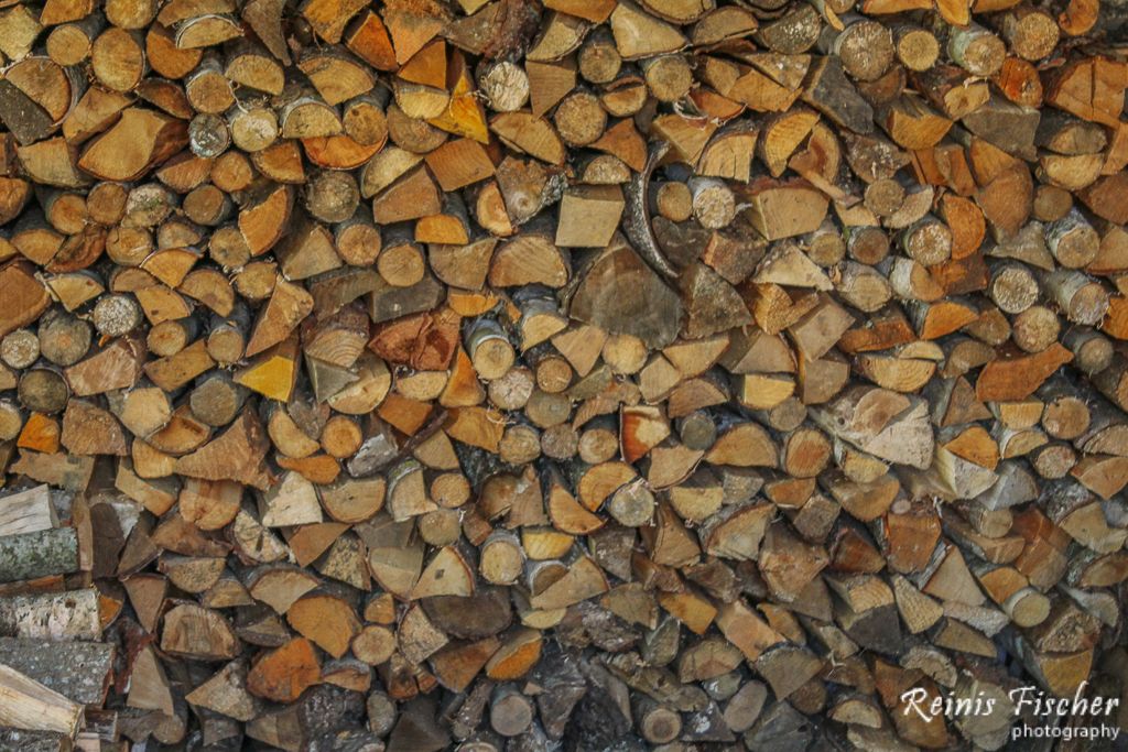 Stacking firewood in barn