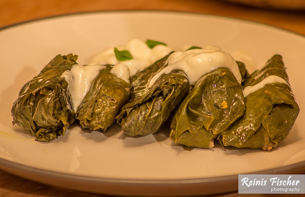 Dolmas dressed with garlic yogurt sauce