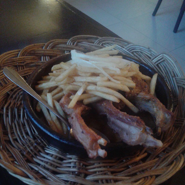 Grilled pork ribs served with French Fries in a hot Adjika sauce