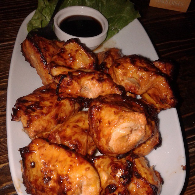 A chicken barbecue served with pomegranate dip