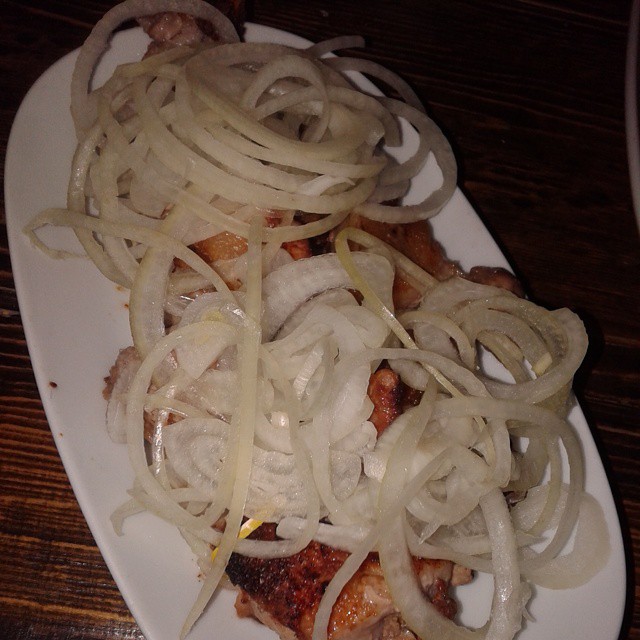 A pork barbecue topped with sliced onions