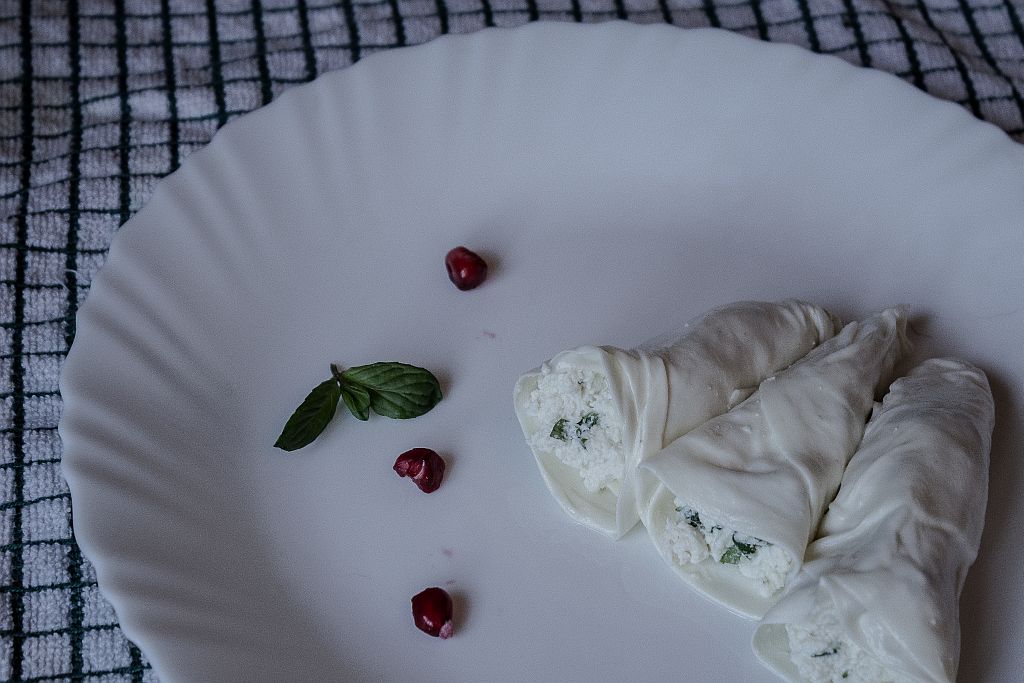 Wrap that fresh cheese blended with mint into those sulguni cheese plates