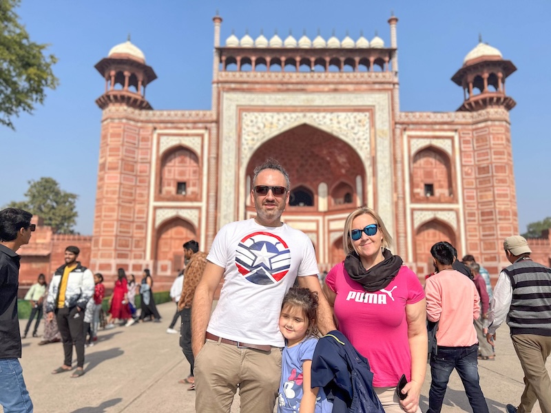 Posing for a family portrait at the entrance of Taj Mahal 